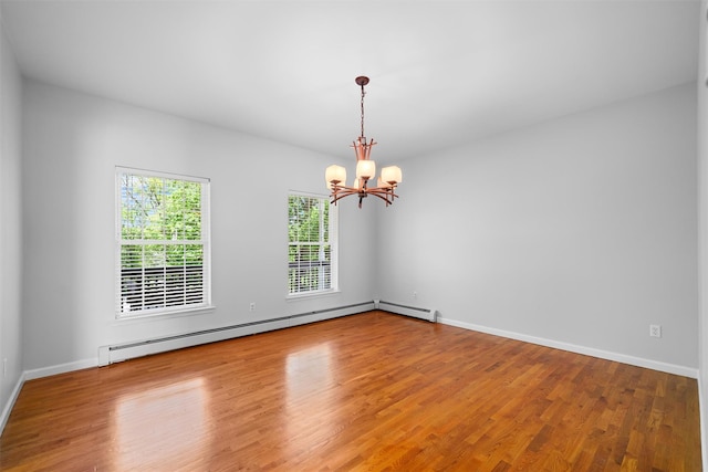 unfurnished room with baseboards, an inviting chandelier, wood finished floors, and a baseboard radiator