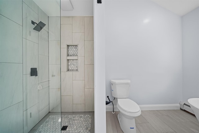 bathroom with baseboards, walk in shower, toilet, and a baseboard heating unit