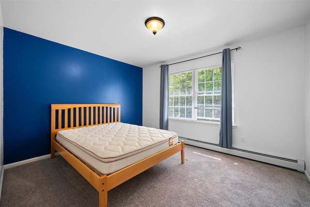 bedroom with baseboards, a baseboard heating unit, and carpet