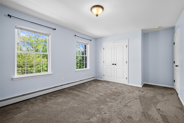 unfurnished bedroom featuring carpet floors, a closet, baseboards, and a baseboard radiator