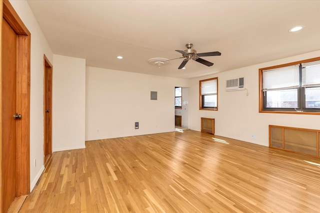 empty room with recessed lighting, a wall mounted air conditioner, light wood finished floors, and ceiling fan
