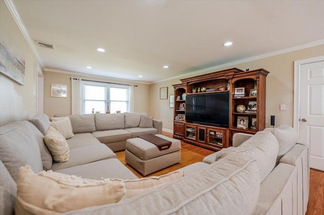 living area with crown molding, recessed lighting, wood finished floors, and visible vents