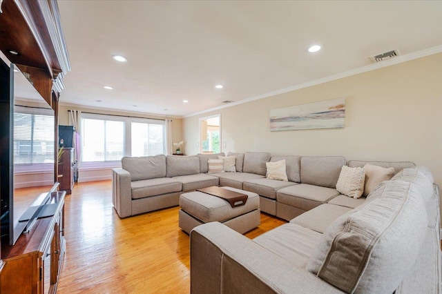 living area with crown molding, recessed lighting, visible vents, and light wood finished floors