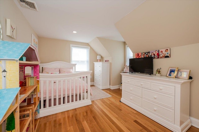 bedroom with light wood-style flooring, recessed lighting, baseboards, vaulted ceiling, and visible vents