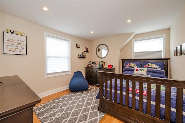 bedroom featuring baseboards, recessed lighting, and wood finished floors