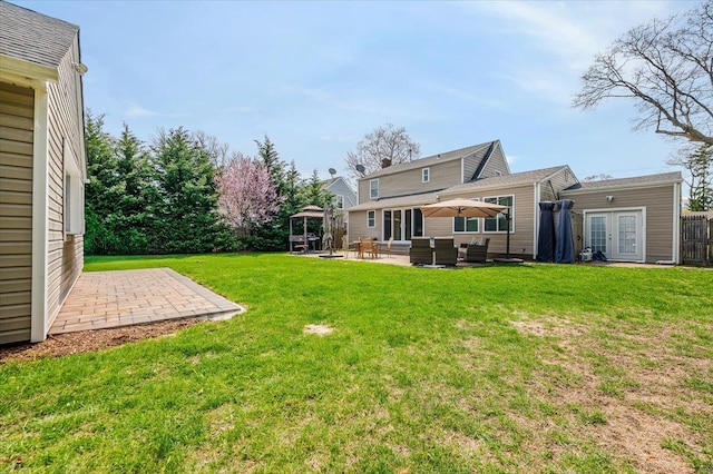 view of yard featuring a gazebo, outdoor lounge area, french doors, and a patio area