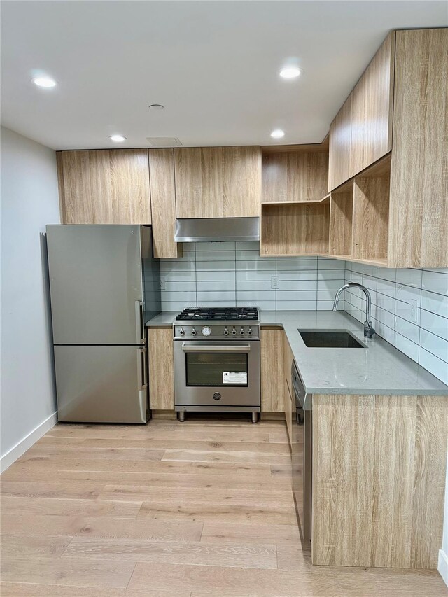 14-33 31st Ave Unit 4H, Astoria, NY 11106 - kitchen featuring light brown cabinets, modern cabinets, ventilation hood, a sink, and stainless steel appliances