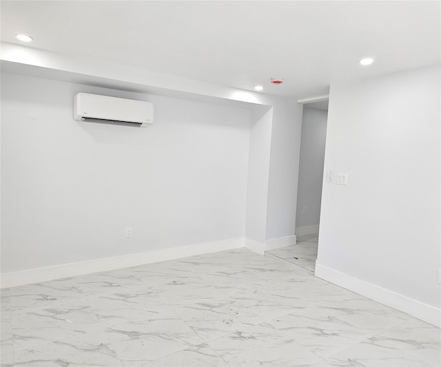 finished basement featuring an AC wall unit, recessed lighting, and marble finish floor