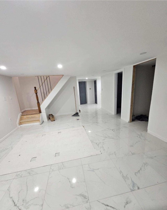 interior space with baseboards, recessed lighting, marble finish floor, and stairs