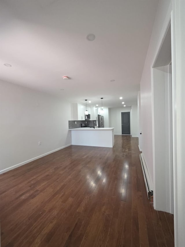 217 E 86th St, Brooklyn, NY 11236 - unfurnished living room featuring a baseboard radiator, dark wood finished floors, baseboards, and recessed lighting