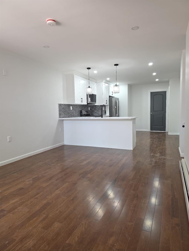 217 E 86th St, Brooklyn, NY 11236 - unfurnished living room with baseboards, recessed lighting, a sink, dark wood-style flooring, and baseboard heating