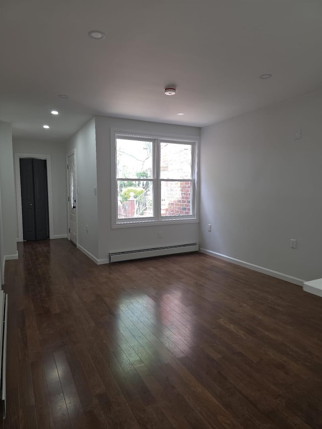 217 E 86th St, Brooklyn, NY 11236 - empty room with baseboard heating, dark wood finished floors, baseboards, and recessed lighting