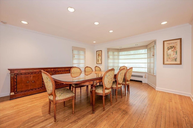 dining space with radiator, recessed lighting, crown molding, baseboards, and light wood-style floors