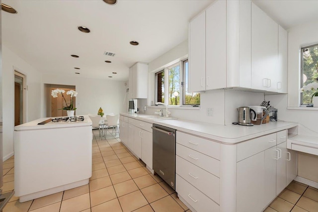 kitchen featuring dishwasher, plenty of natural light, visible vents, and a sink