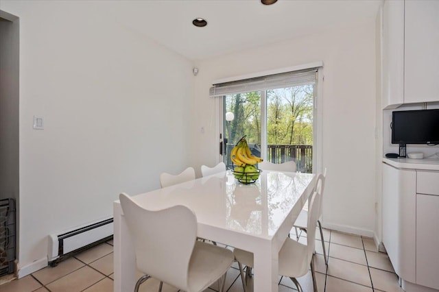 dining space with light tile patterned floors, baseboards, and baseboard heating