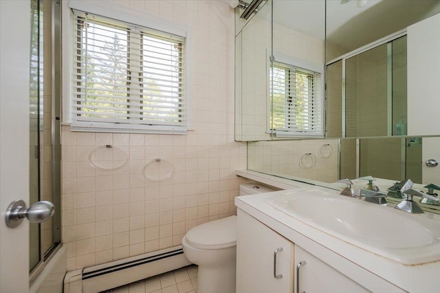 full bathroom featuring tile walls, a baseboard heating unit, toilet, tile patterned flooring, and vanity