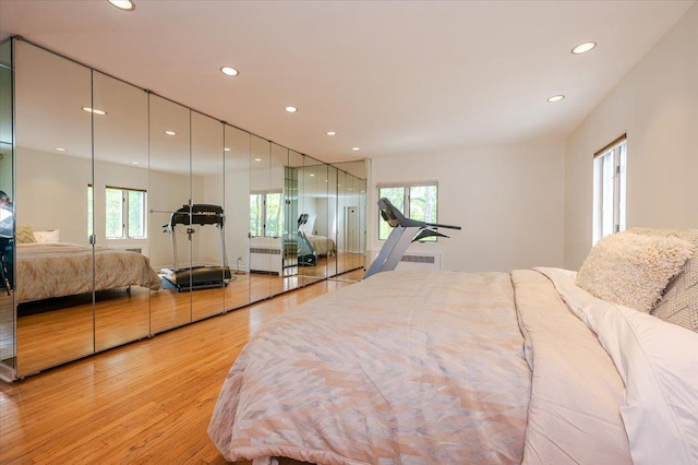 bedroom featuring light wood finished floors and recessed lighting