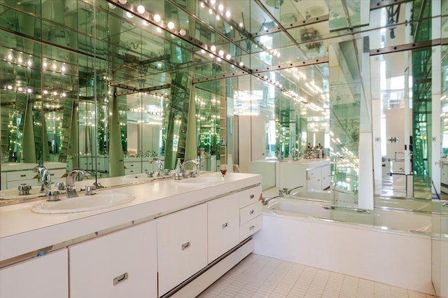 full bath with a bath, tile patterned flooring, and a sink