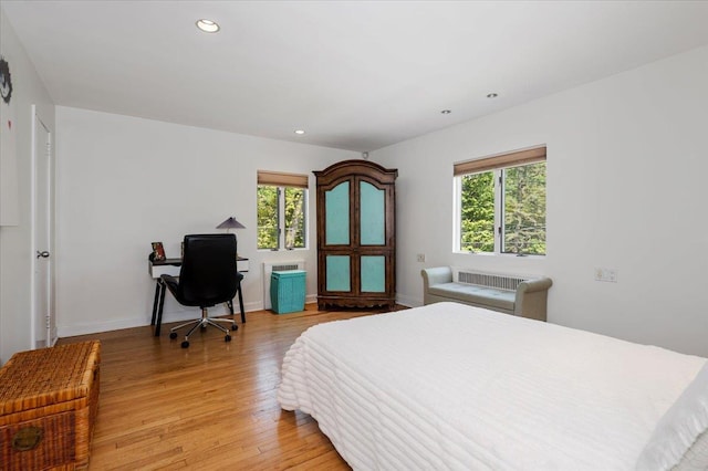 bedroom with light wood-style flooring, baseboards, recessed lighting, and multiple windows