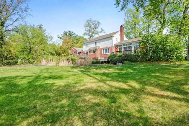 view of yard featuring a wooden deck