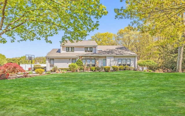 traditional home with a front yard and fence