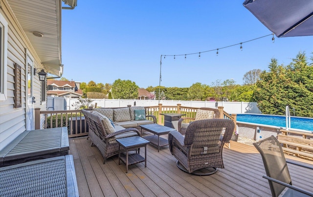 wooden terrace with a fenced backyard, a fenced in pool, and outdoor lounge area