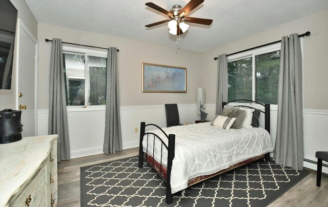 bedroom with ceiling fan and wood finished floors