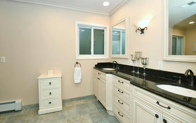 full bathroom with a sink, a baseboard radiator, ornamental molding, and visible vents