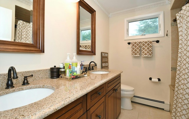 bathroom featuring a sink, tile patterned flooring, toilet, and baseboard heating