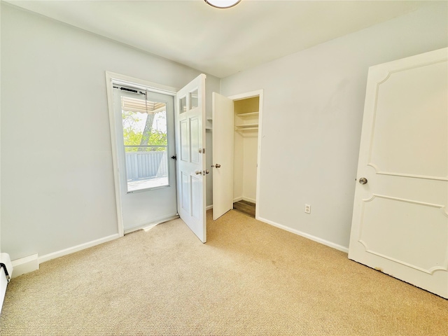 unfurnished bedroom featuring baseboards and light carpet