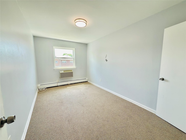 spare room featuring carpet floors, a baseboard radiator, and baseboards