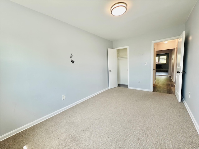 unfurnished bedroom featuring carpet floors, baseboards, and a closet