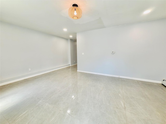 unfurnished room with recessed lighting and baseboards