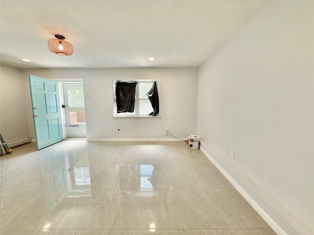 spare room with recessed lighting, baseboards, and a baseboard heating unit