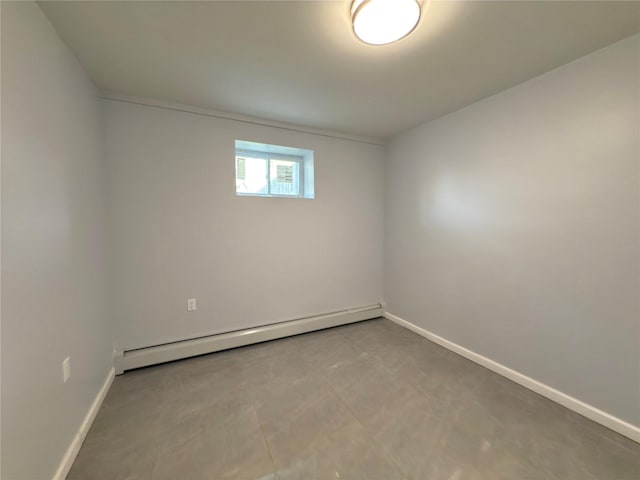 unfurnished room featuring baseboards and a baseboard radiator