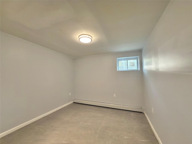 unfurnished room featuring baseboards and baseboard heating