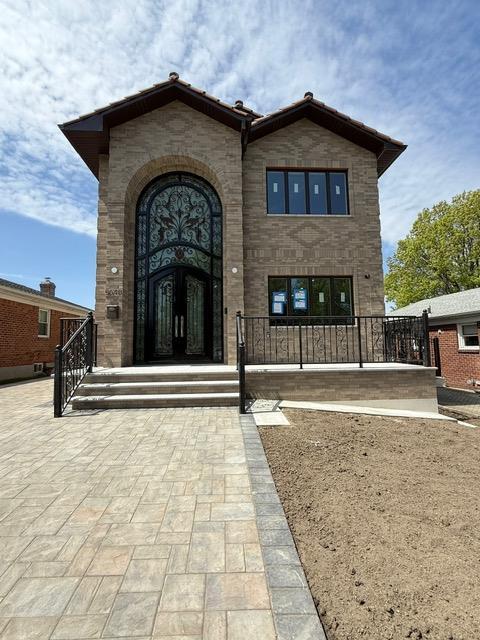entrance to property featuring brick siding and stone siding