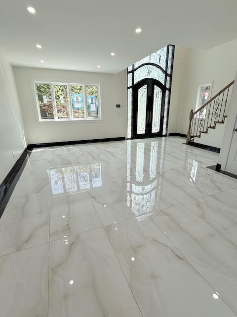entrance foyer featuring recessed lighting, marble finish floor, and stairs