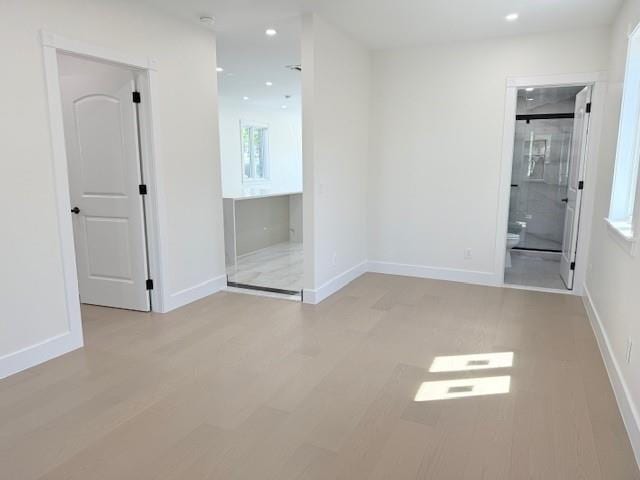 spare room featuring recessed lighting, baseboards, and wood finished floors