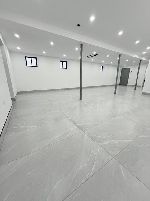 basement featuring recessed lighting and baseboards