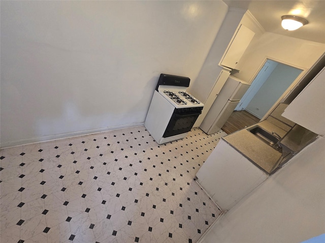1475 Thieriot Ave Unit 4J, Bronx, NY 10460 - kitchen featuring light floors, a sink, white range with gas cooktop, and baseboards