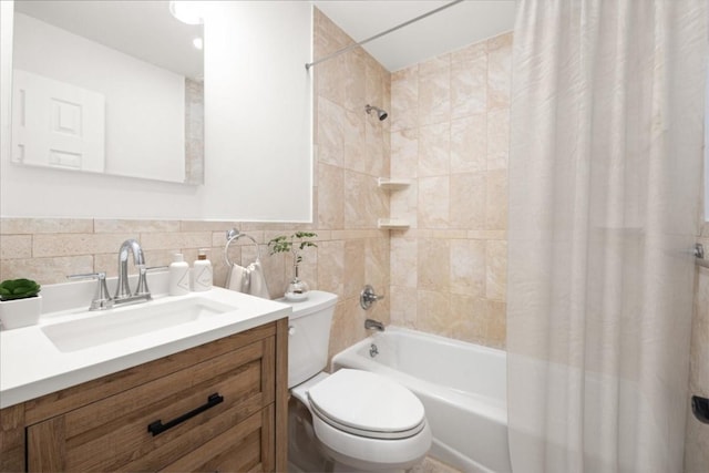 full bathroom with shower / tub combo, toilet, vanity, and tile walls