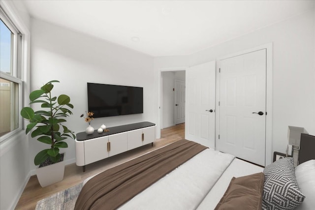 bedroom featuring wood finished floors and baseboards
