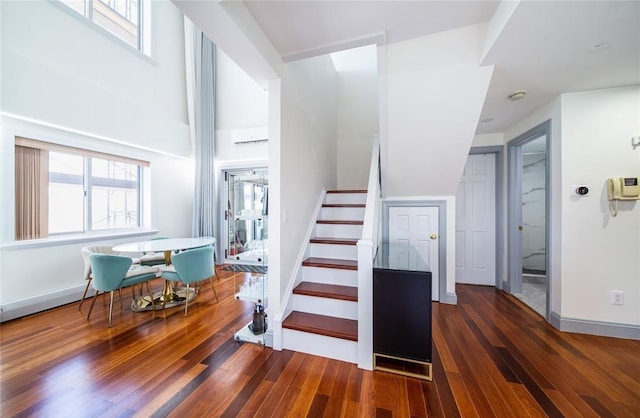 stairs featuring baseboards and wood finished floors
