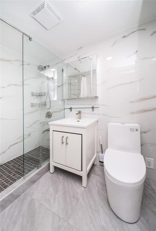 full bath with visible vents, marble finish floor, a marble finish shower, and toilet