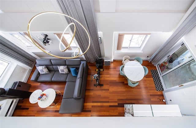 living area featuring wood finished floors, a wealth of natural light, and a skylight