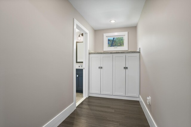 hallway with baseboards and dark wood finished floors