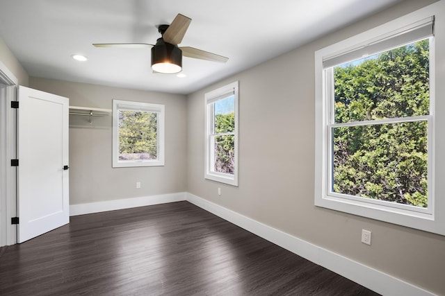 unfurnished bedroom featuring ceiling fan, recessed lighting, baseboards, dark wood-type flooring, and a closet