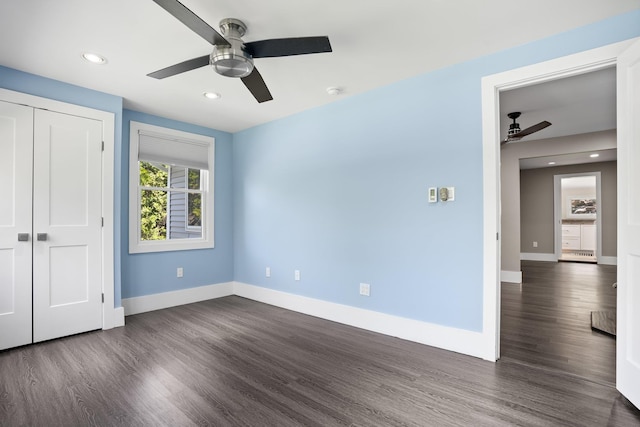 unfurnished bedroom featuring recessed lighting, baseboards, dark wood finished floors, and a closet