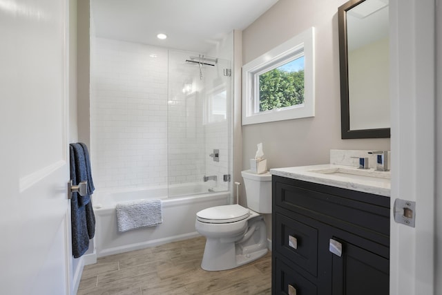 bathroom with vanity, shower / bathing tub combination, toilet, and wood finished floors